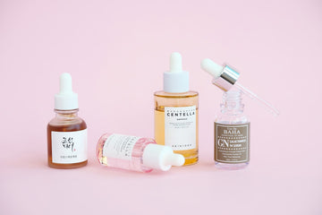 Galactomyces Korean Skincare serums and essences on pink background